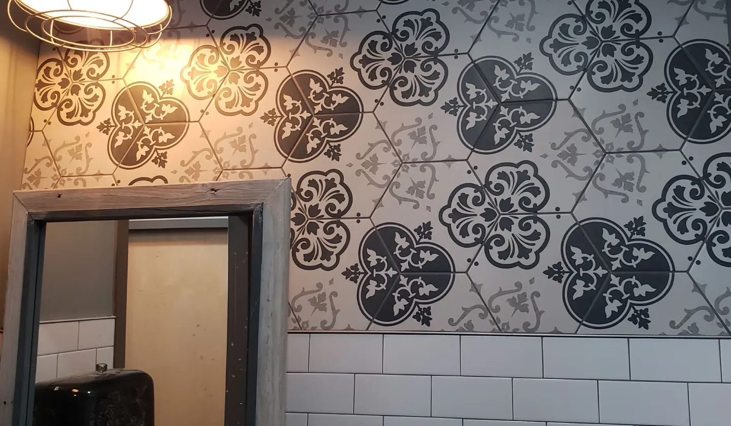 A wall with some black and white designs on it