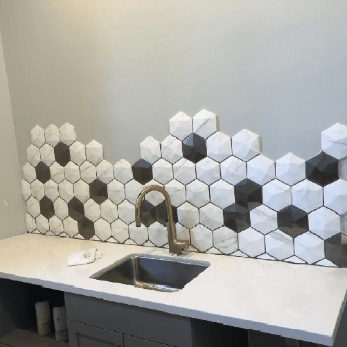 A sink and counter in a room with white walls.