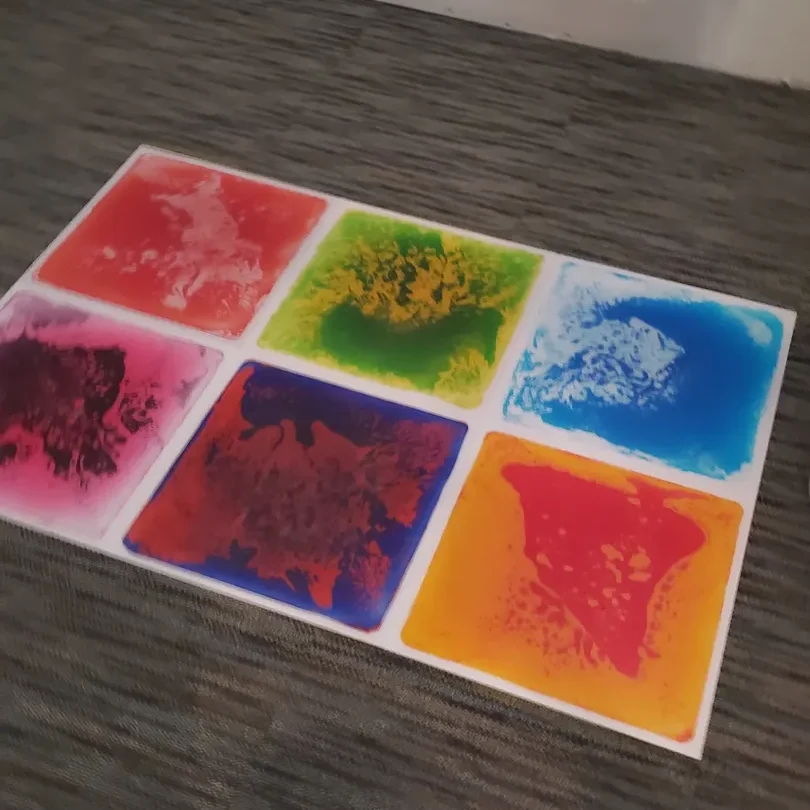 A picture of six different colored squares on the floor.