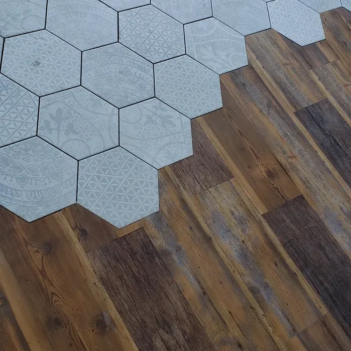 A floor with wood and tile in it